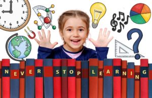Child raising up hands over a row of books whose binders read "Never stop Learning"